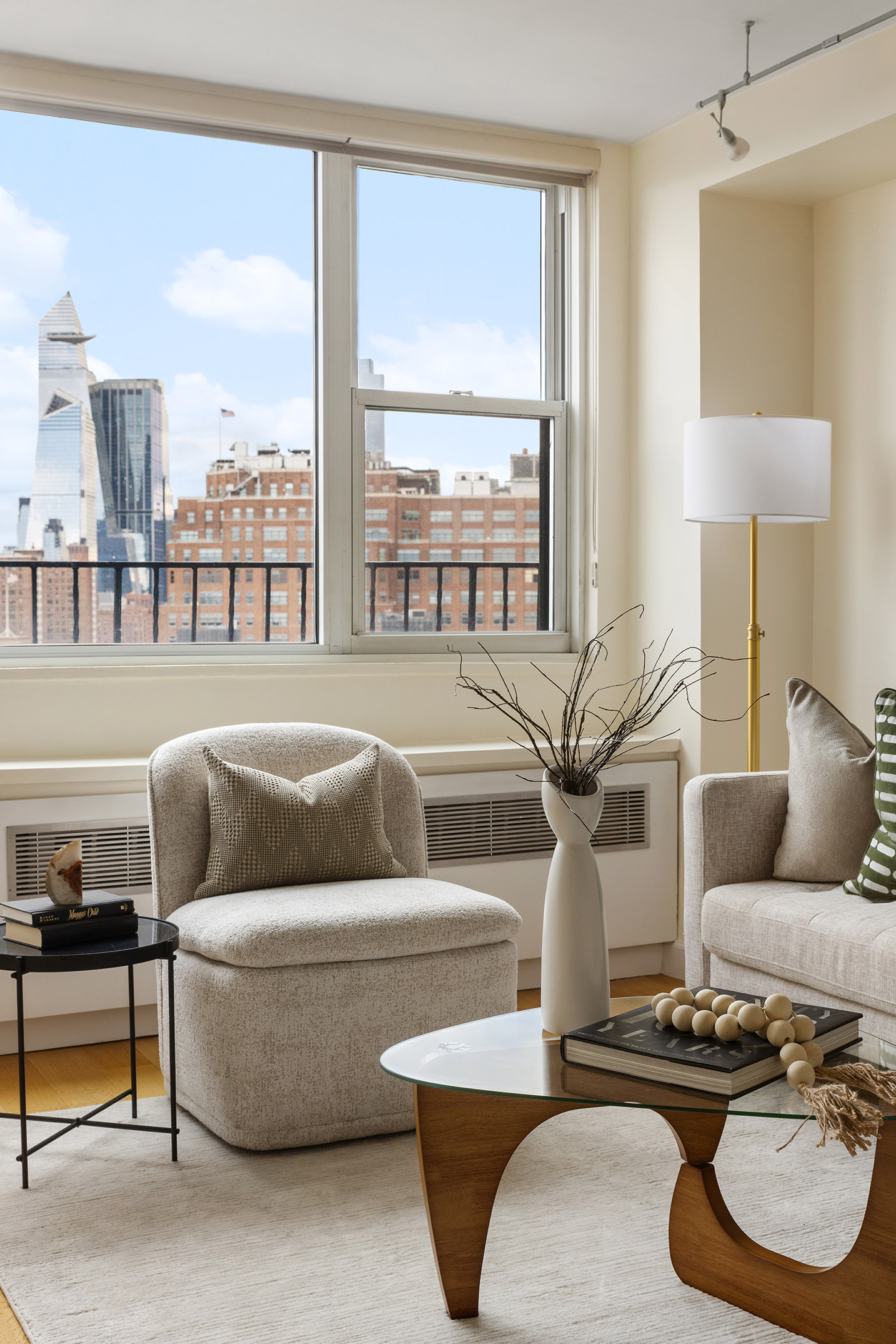 61 Jane Street, Unit 19J Manhattan, NY 10014 - Photo 3 of 12 a living room with furniture and a large window