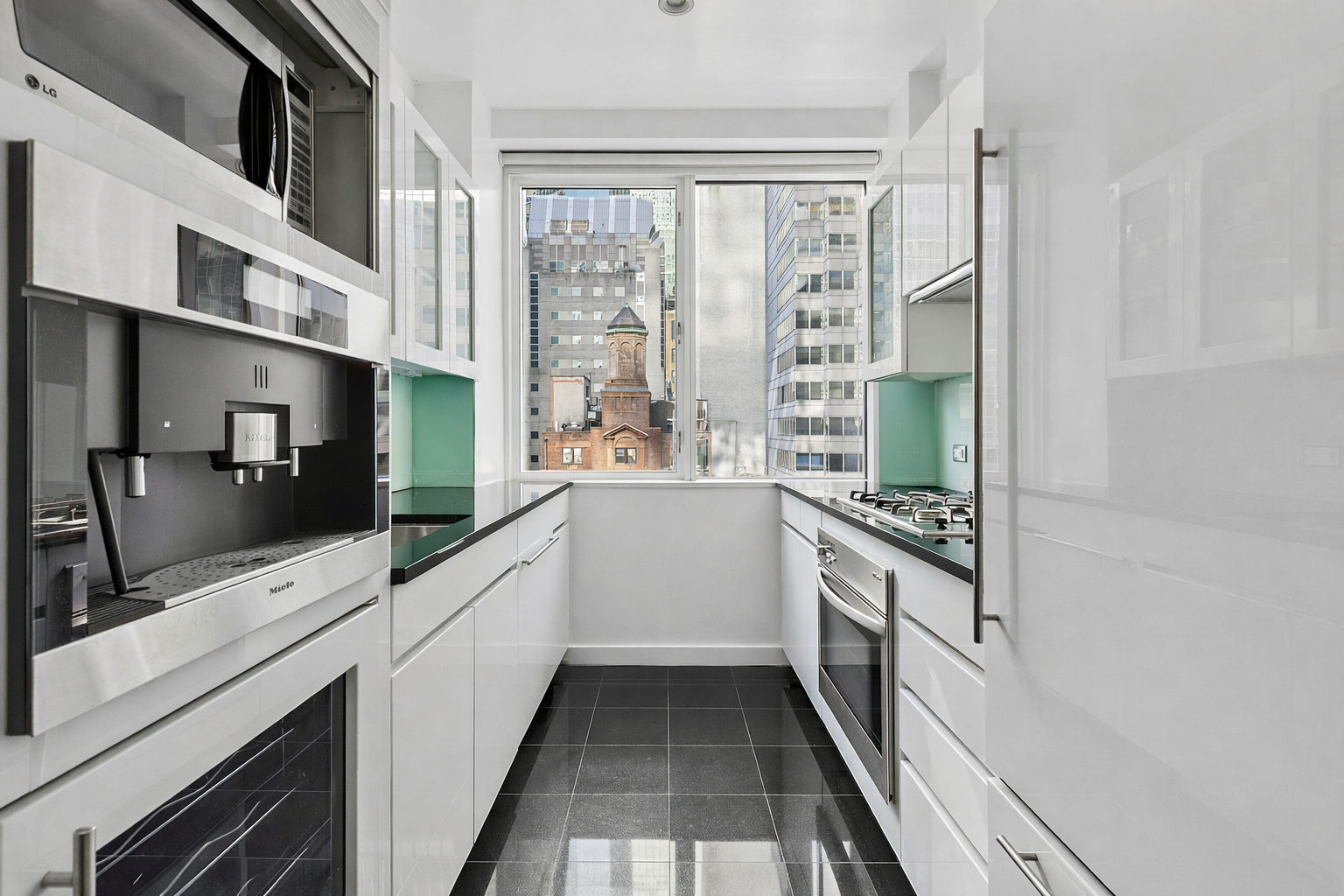 60 East 55th Street, Unit 20A Manhattan, NY 10022 - Photo 3 of 9 a large white kitchen with a large window