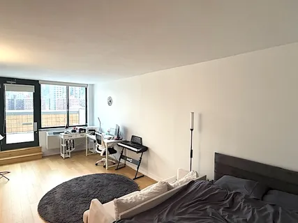 a living room with furniture and large windows