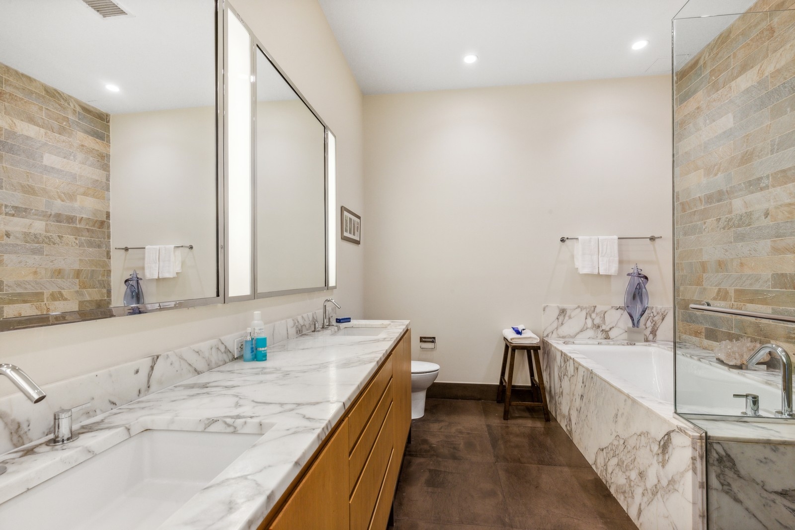 263 9th Avenue, Unit 3D Manhattan, NY 10001 - Photo 10 of 15 a bathroom with a granite countertop double vanity sink and a bathtub