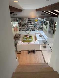 a view of kitchen with stainless steel appliances dining table and chairs