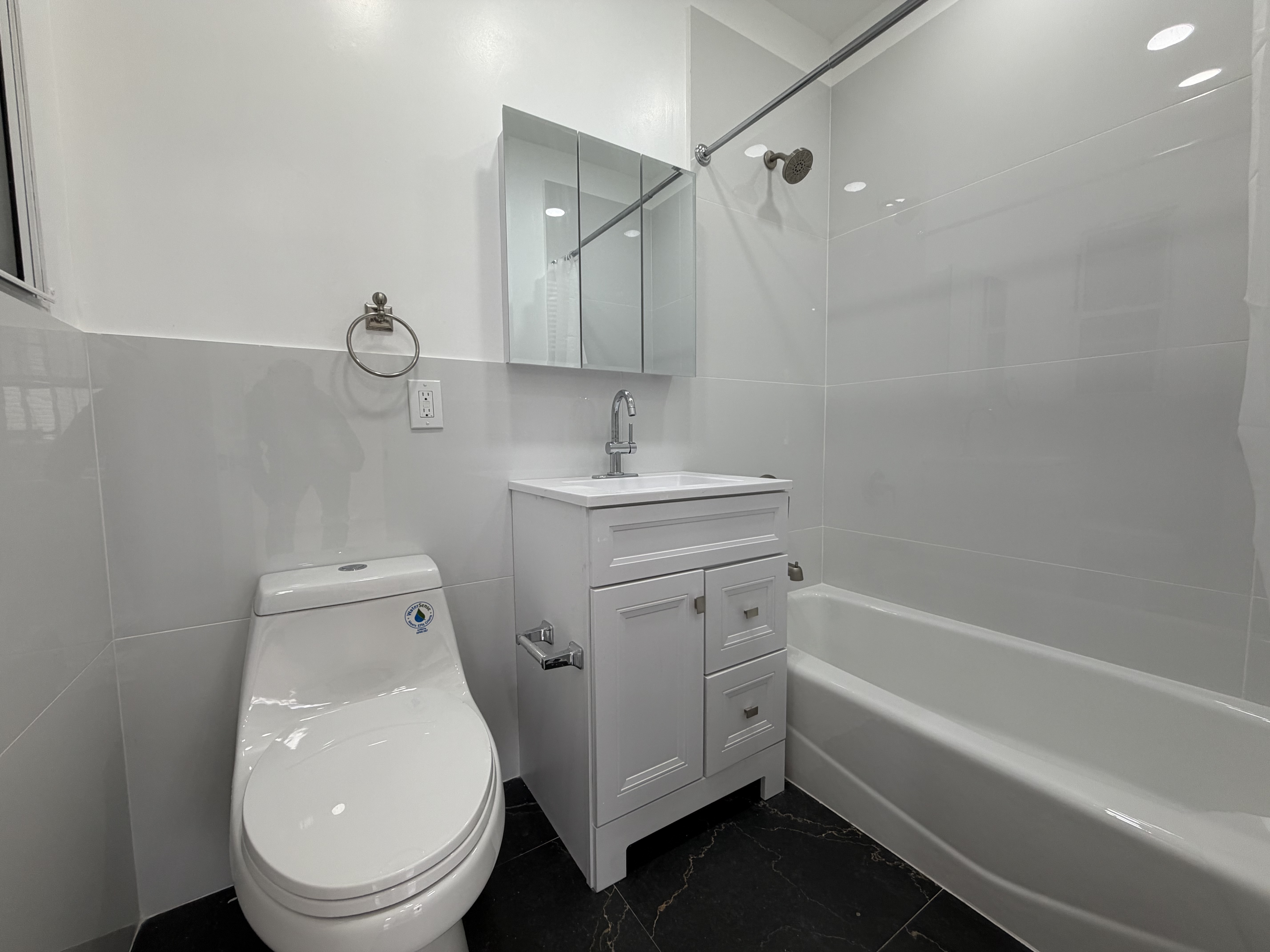 18-61 Dekalb Avenue, Unit 1 Queens, NY 11385 - Photo 5 of 12 a bathroom with a sink a toilet and shower