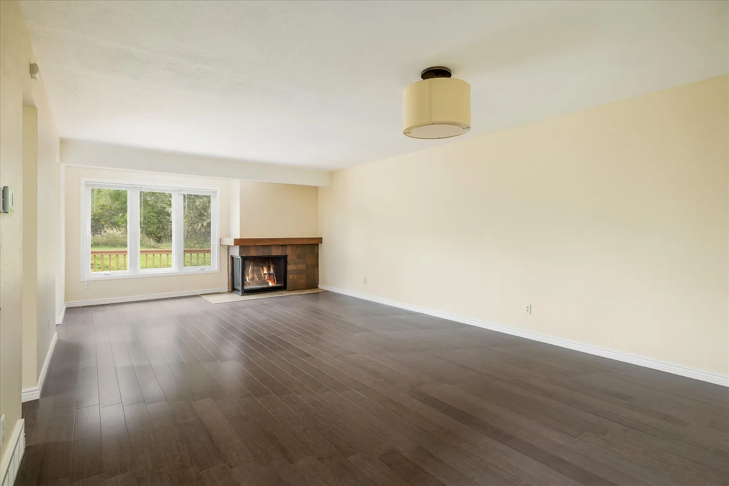 a room with a fireplace and a wooden floor