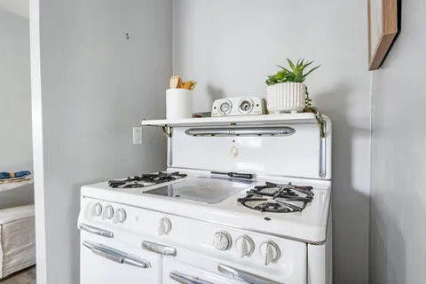 a kitchen with a stove and a refrigerator