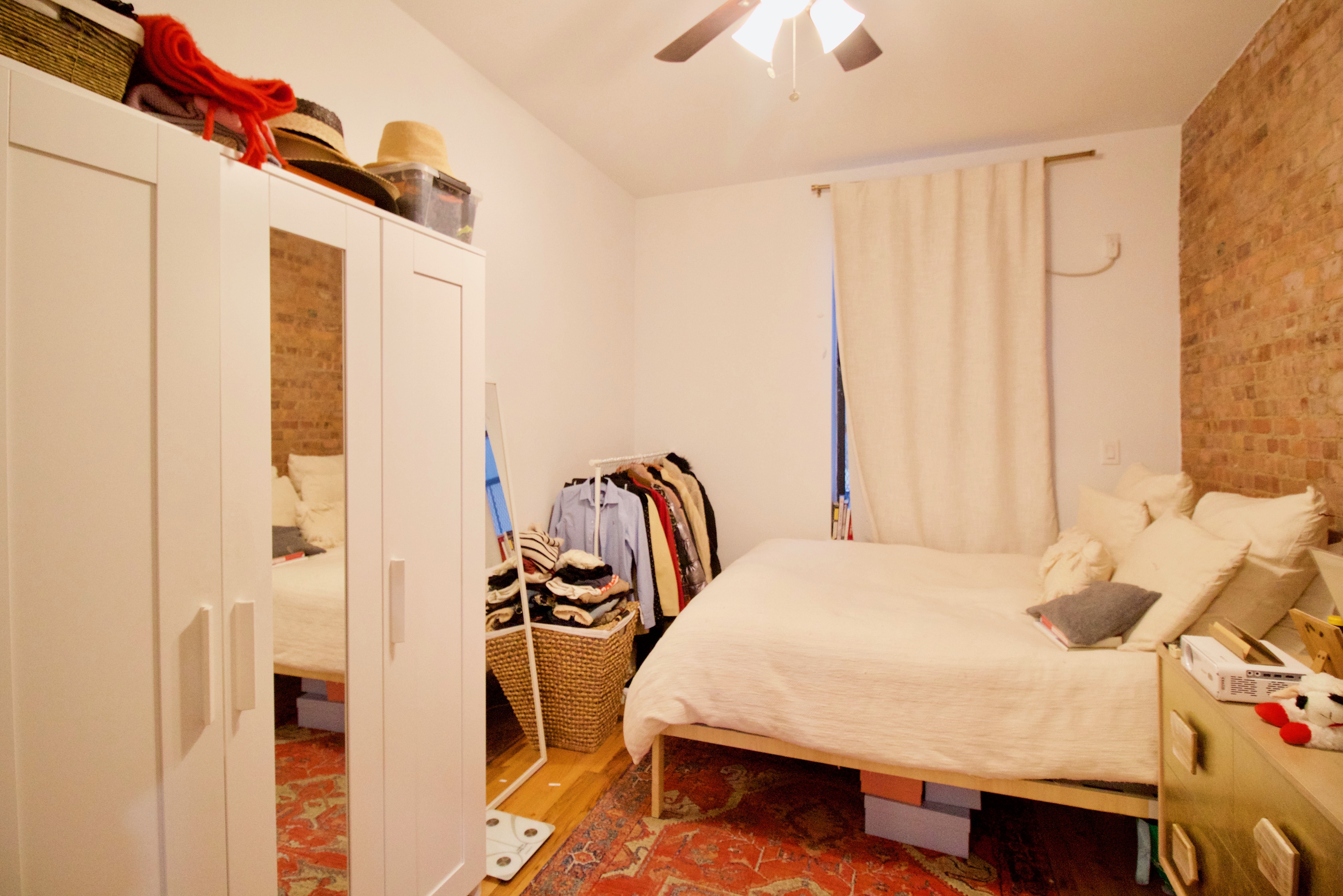 134 Union Street, Unit 2R Brooklyn, NY 11231 - Photo 18 of 23 a bedroom with a bed and a chandelier