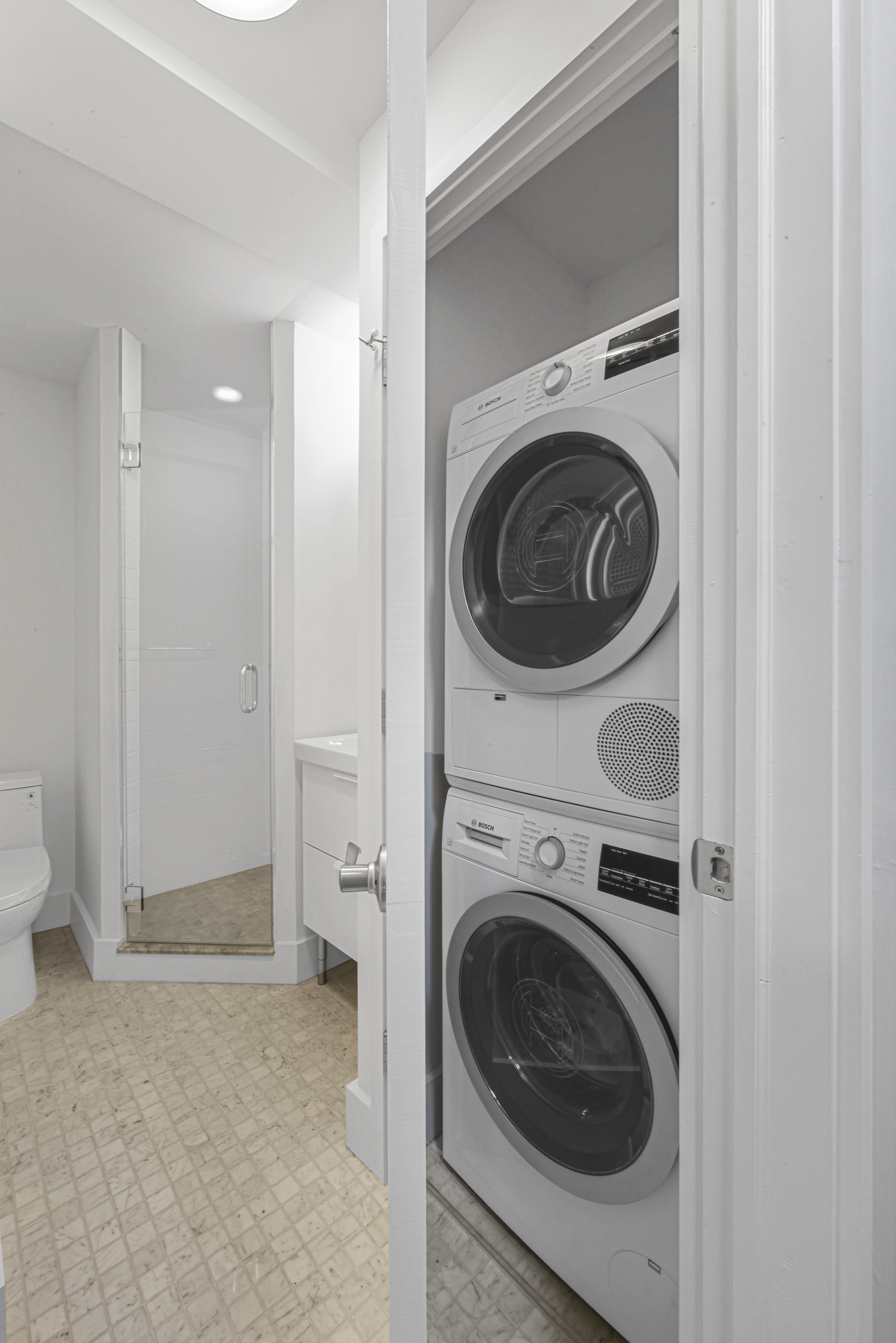 9511 Shore Road, Unit 505 Brooklyn, NY 11209 - Photo 10 of 18 a view of a hallway with washer and dryer