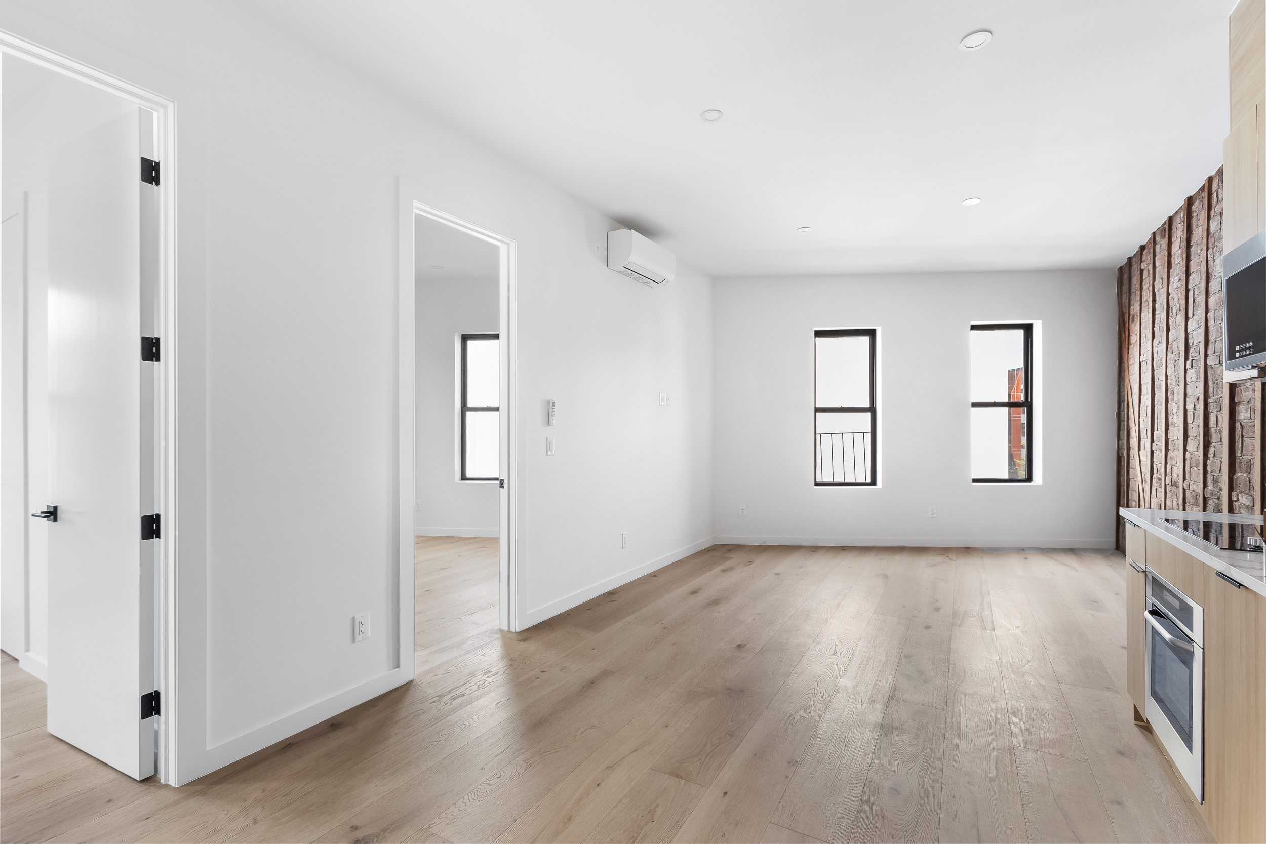 92 Jefferson Street, Unit 4 Brooklyn, NY 11206 - Photo 1 of 9 an empty room with wooden floor and windows
