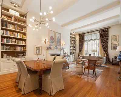 a dining room with furniture window and wooden floor