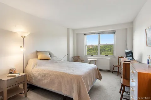 a bedroom with a large bed and a flat screen tv