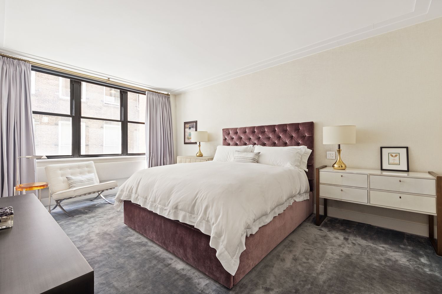 a large bed sitting in a bedroom next to a window