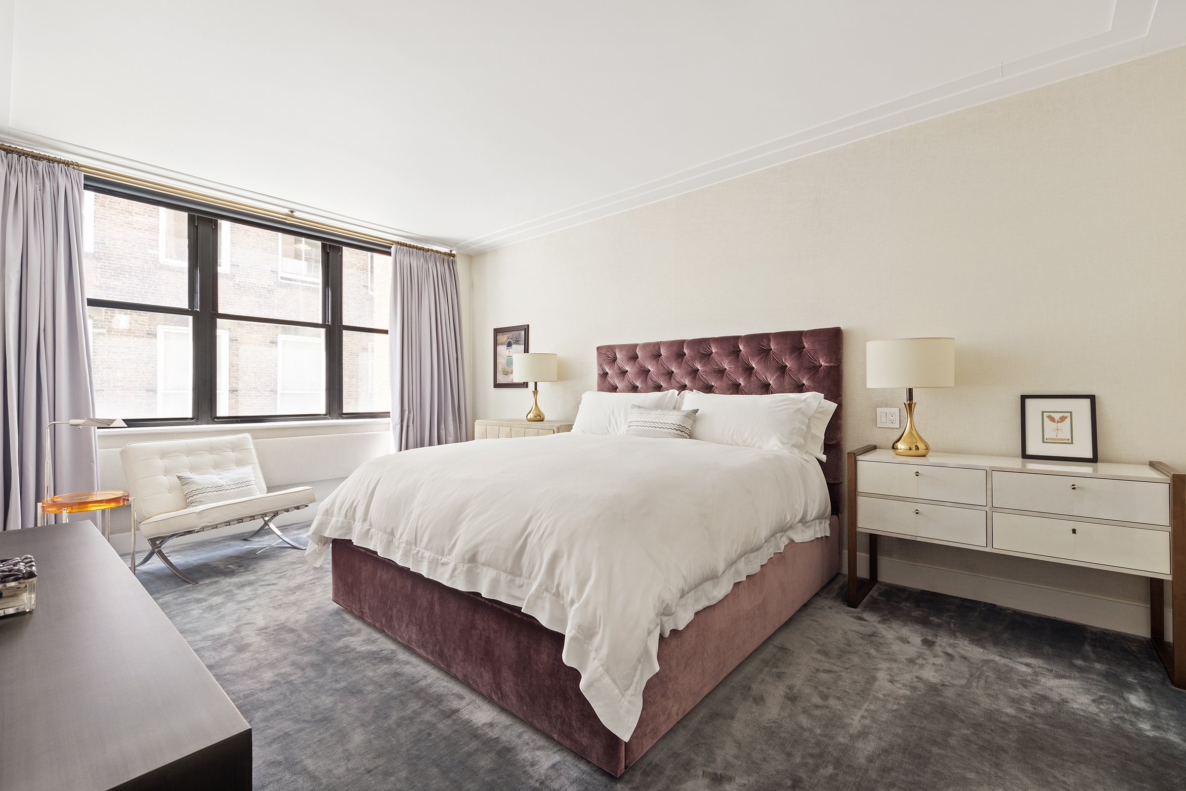 109 Greene Street, Unit 2C Manhattan, NY 10012 - Photo 5 of 13 a large bed sitting in a bedroom next to a window