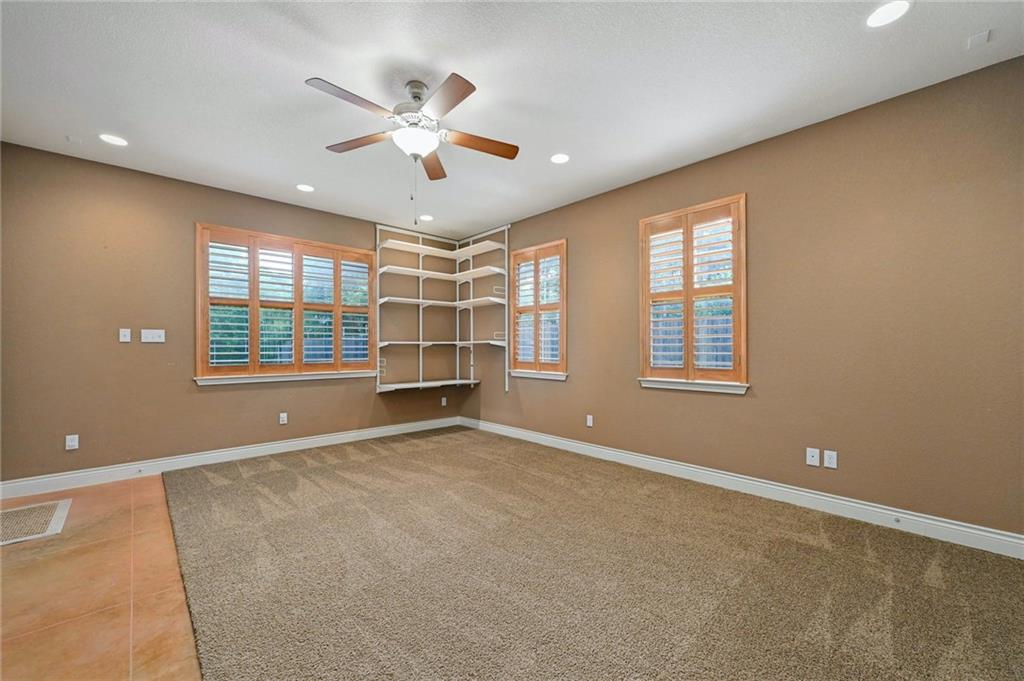 1102 Clermont Avenue Austin, TX 78702 - Photo 15 of 30 an empty room with windows and ceiling fan