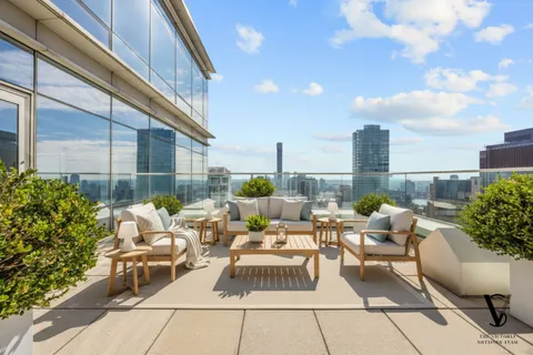 a view of a terrace with furniture and a potted plant