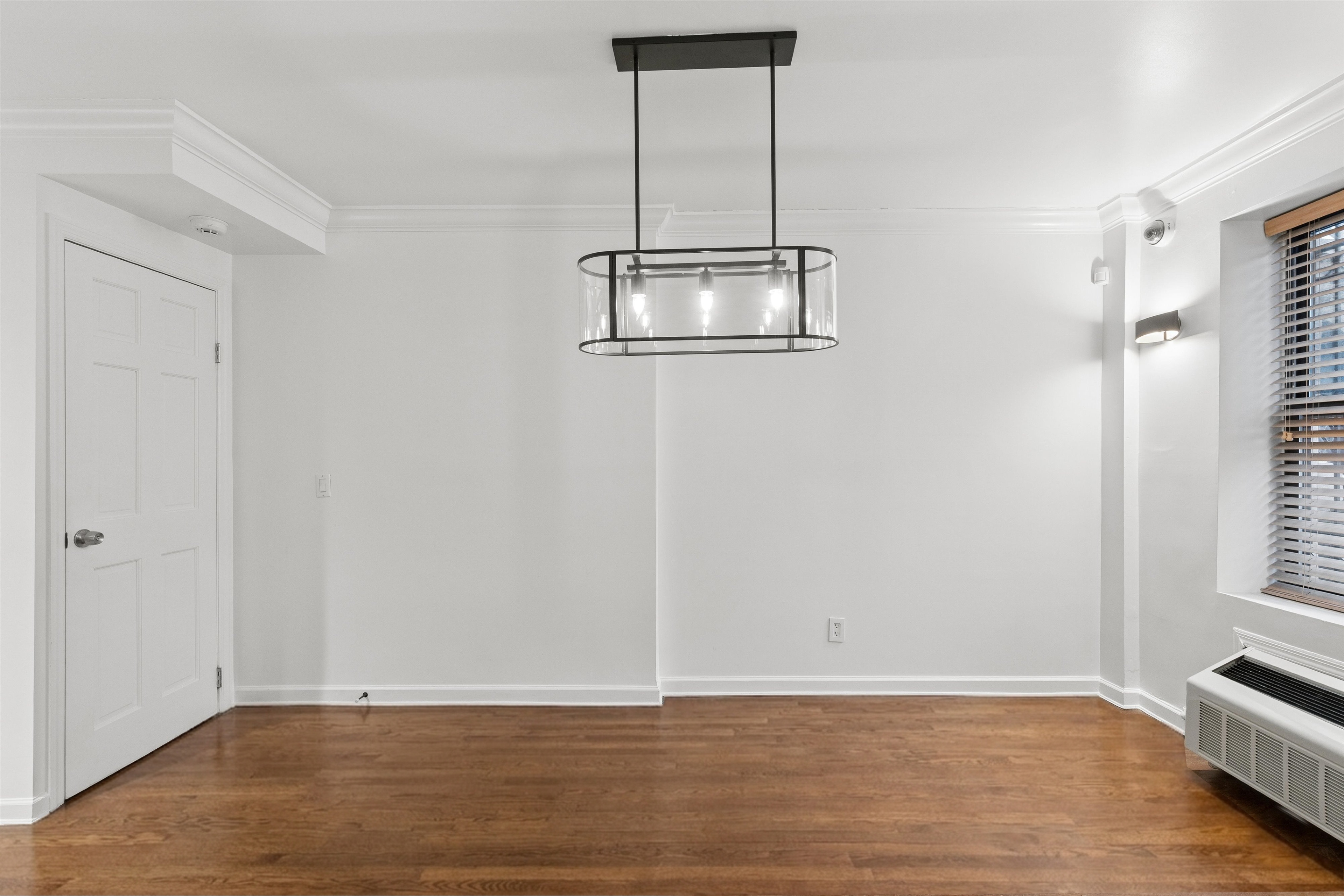 165 West 126th Street Manhattan, NY 10027 - Photo 5 of 40 a view of an empty room with wooden floor and a window