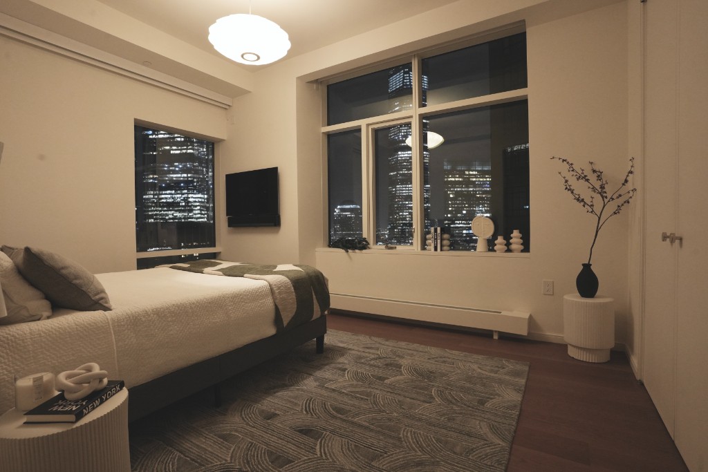 5 Beekman Street, Unit 43A Manhattan, NY 10038 - Photo 13 of 33 a bedroom with a bed and a large window