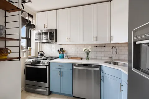 a kitchen with stainless steel appliances granite countertop a sink stove and microwave