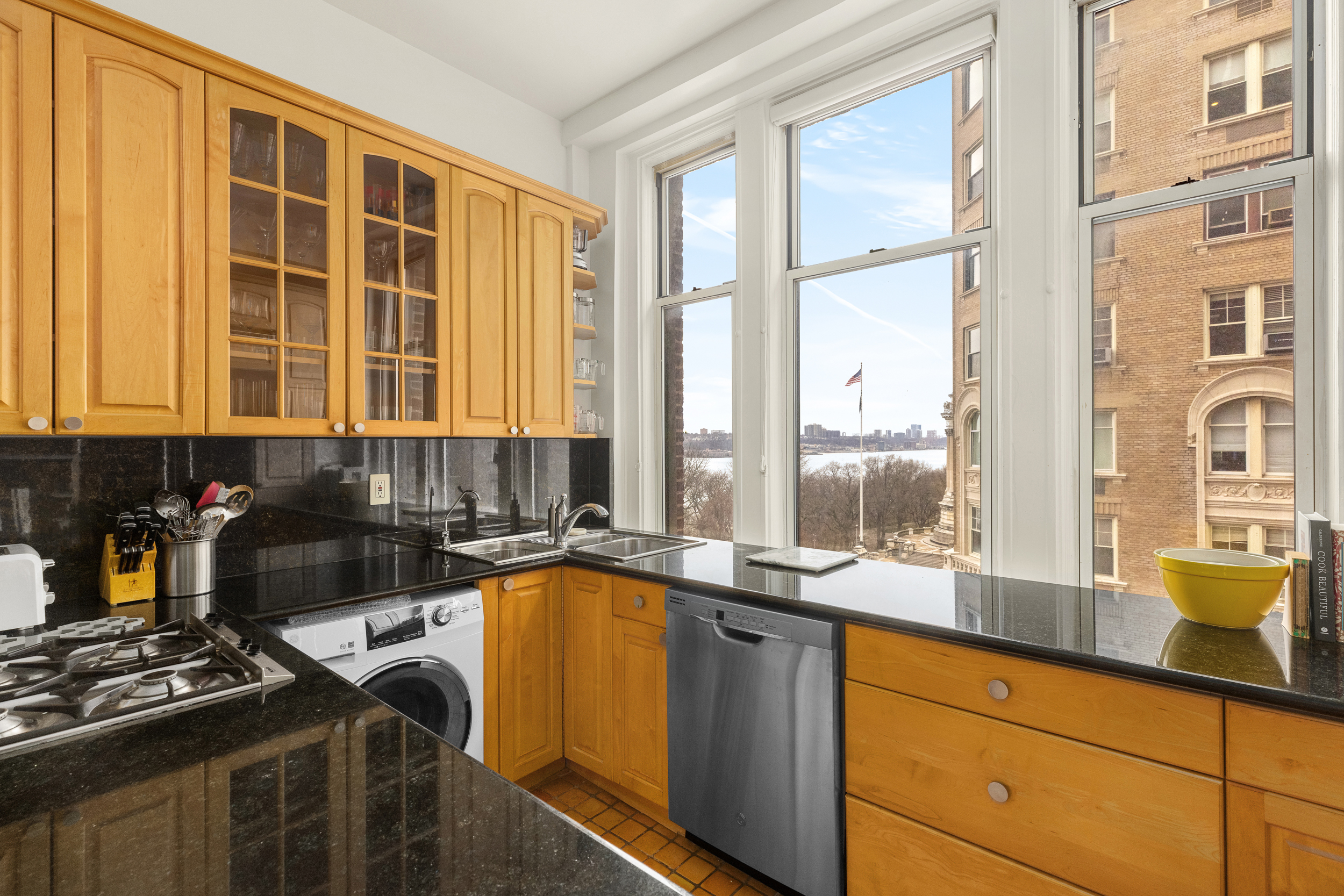 155 Riverside Drive, Unit 6B Manhattan, NY 10024 - Photo 4 of 8 a kitchen with a sink stove and cabinets