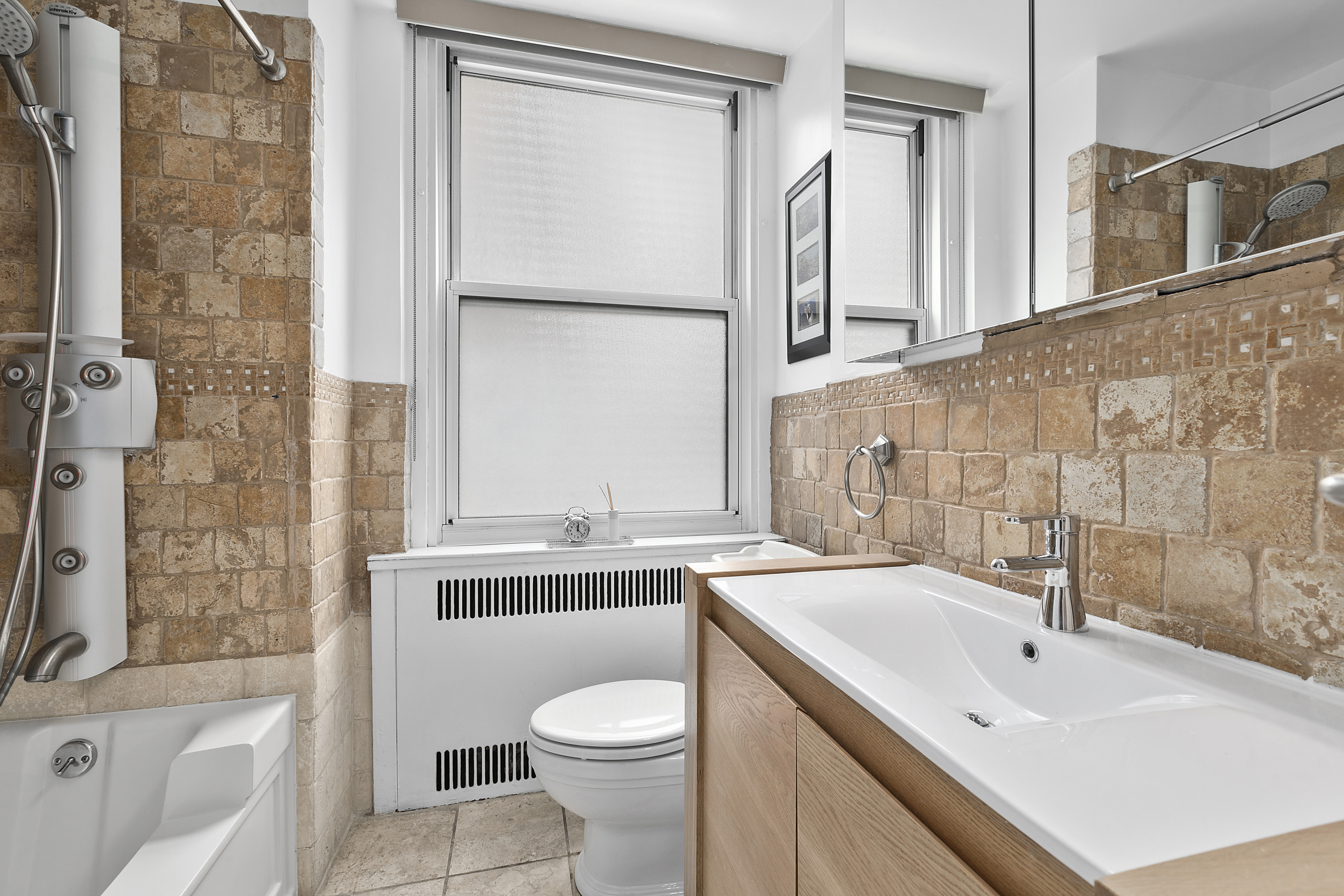 263 West End Avenue, Unit 2C Manhattan, NY 10023 - Photo 6 of 13 a bathroom with a sink toilet and shower