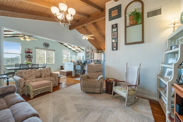 a living room with furniture and a chandelier