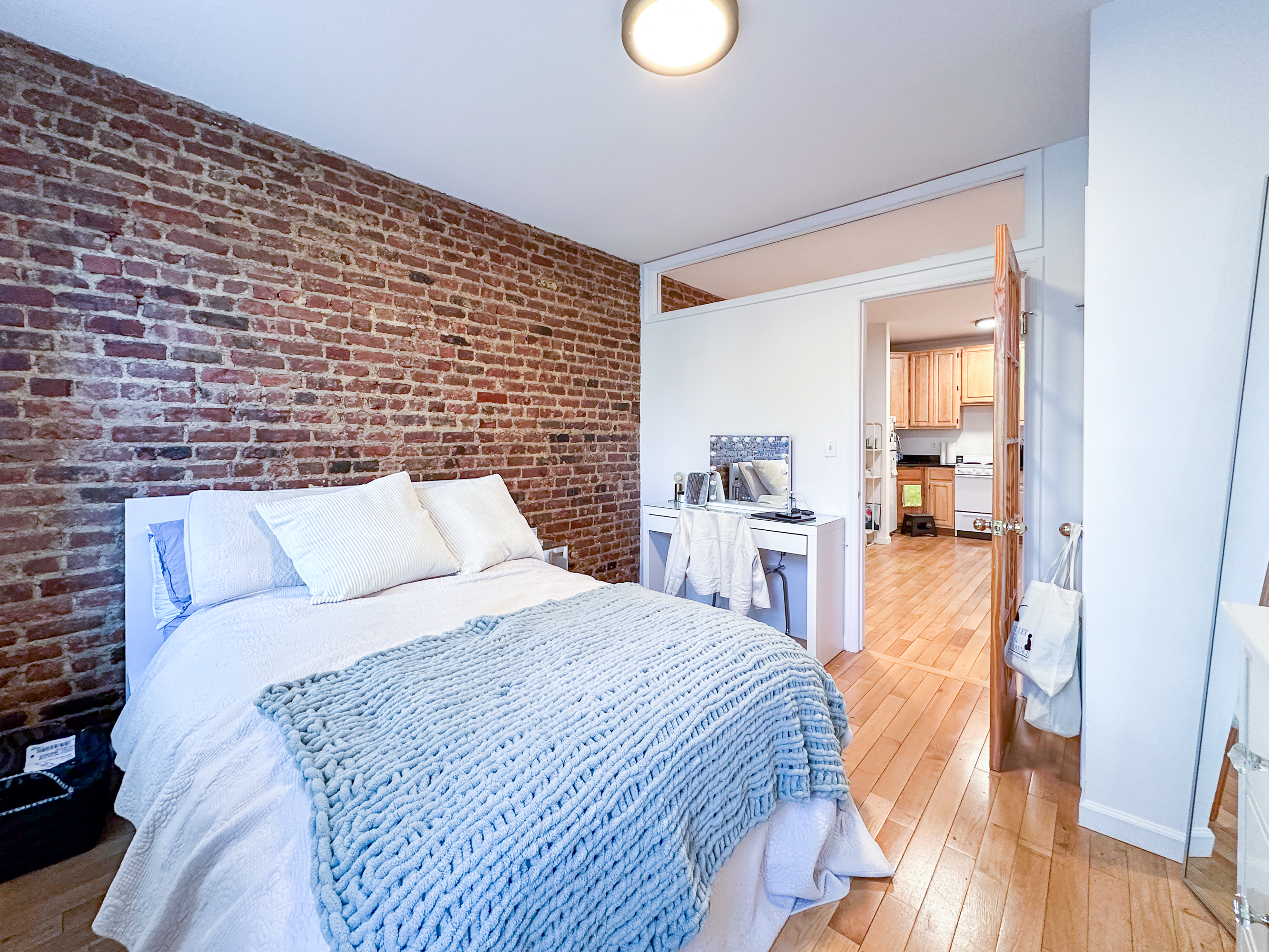 315 East 5th Street, Unit 5E Manhattan, NY 10003 - Photo 2 of 11 a bedroom with a bed and a view of living room