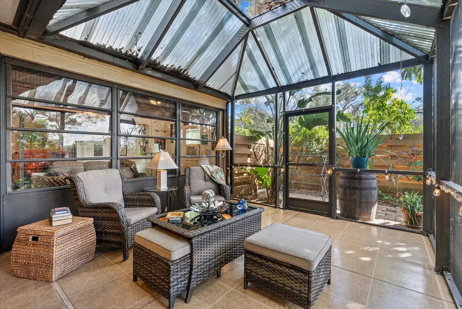 a living room with furniture and a floor to ceiling window