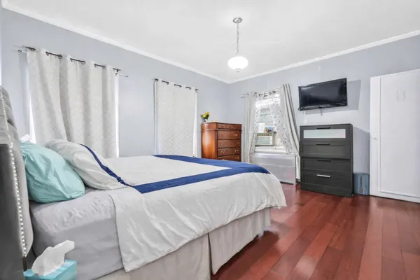 a bedroom with a bed and a television