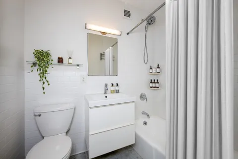 a bathroom with a toilet a sink and a mirror