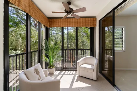 a living room with couch and a floor to ceiling window