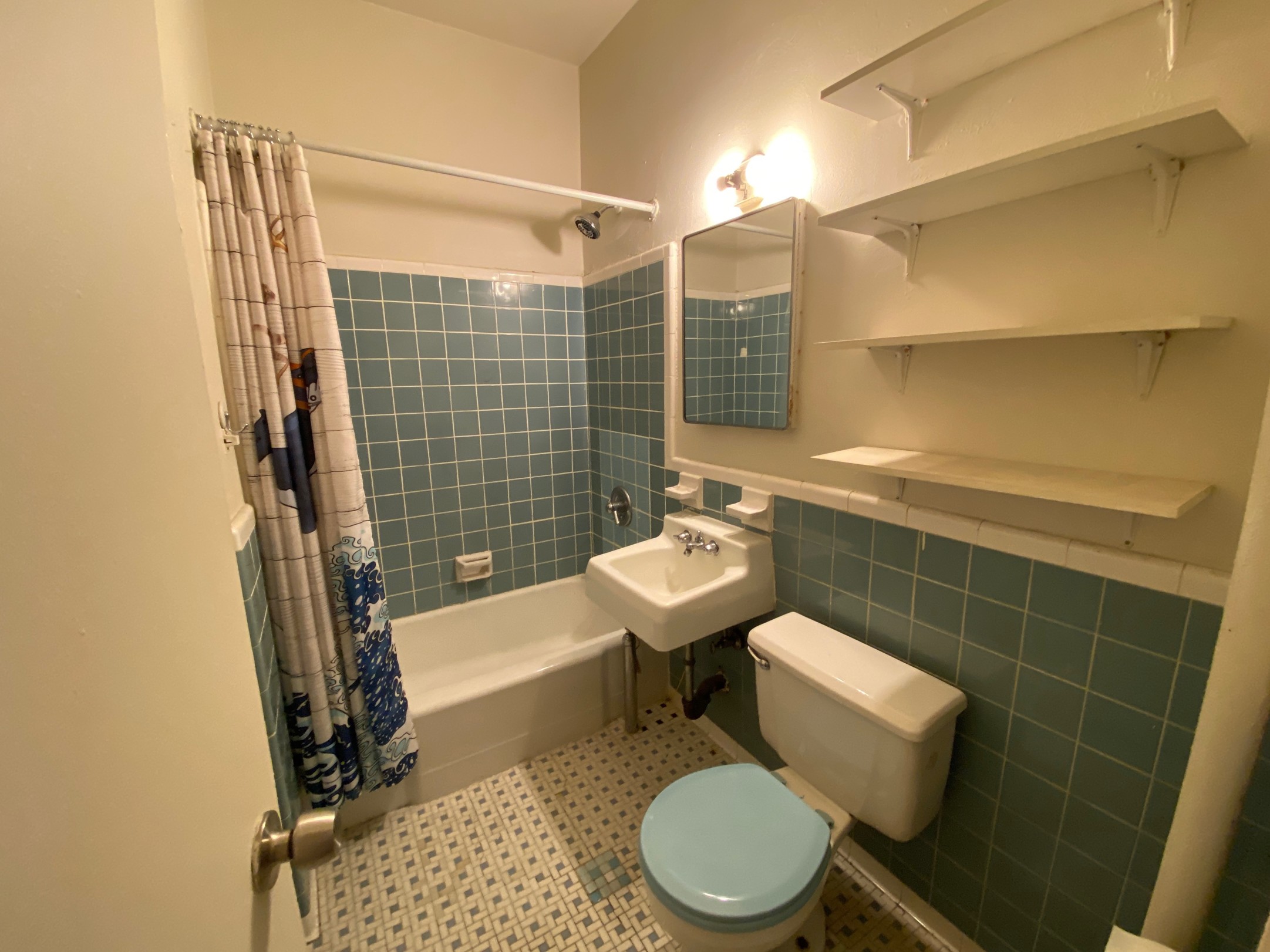 153 East 43rd Street, Unit 5A Manhattan, NY 10017 - Photo 6 of 7 a bathroom with a sink a toilet and shower