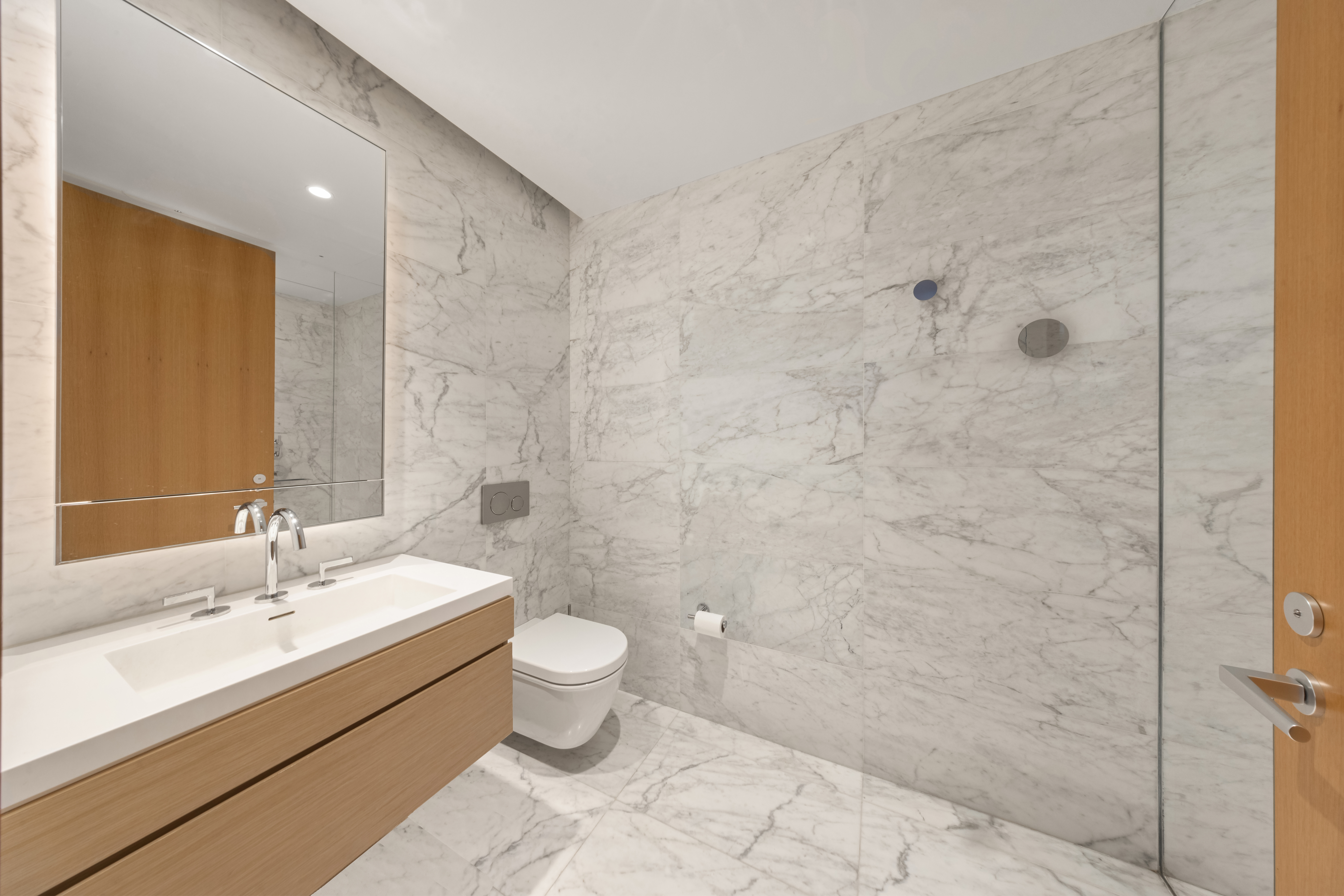 565 Broome Street, Unit N5E Manhattan, NY 10013 - Photo 6 of 16 a bathroom with a sink and a mirror
