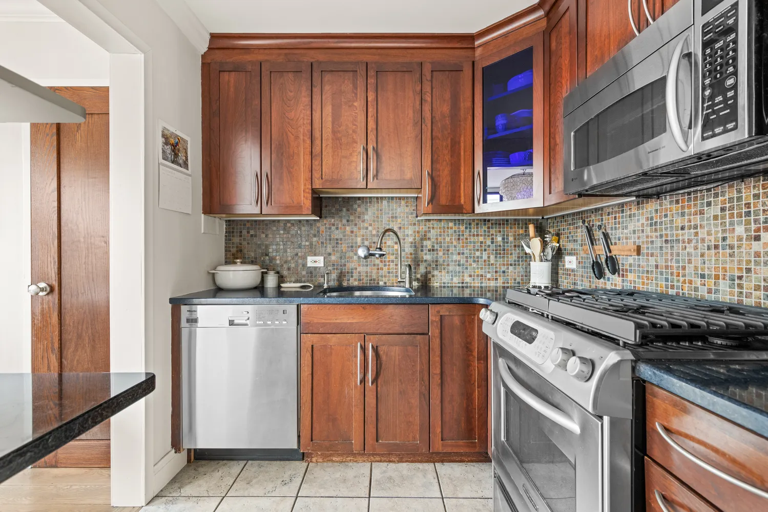 a kitchen with stainless steel appliances granite countertop a stove and a refrigerator