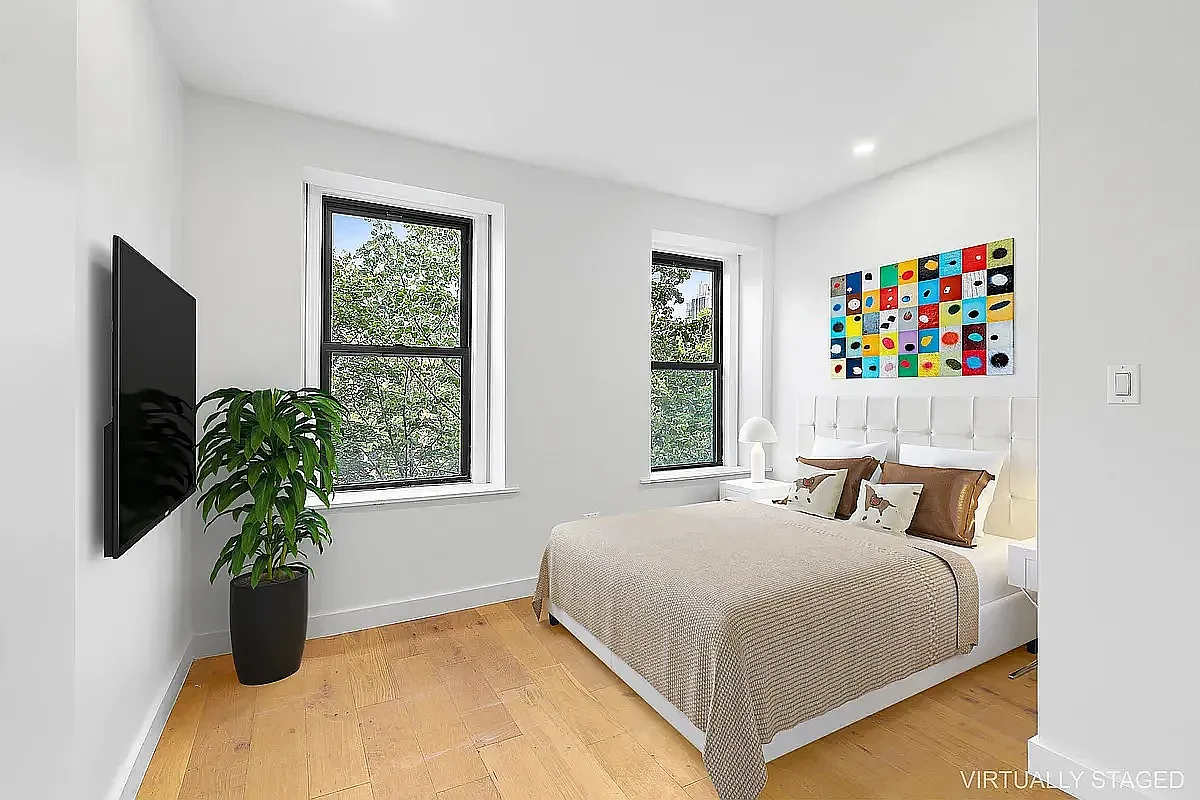 82 Clinton Avenue, Unit 4 Brooklyn, NY 11205 - Photo 5 of 11 a bedroom with a bed and a potted plant