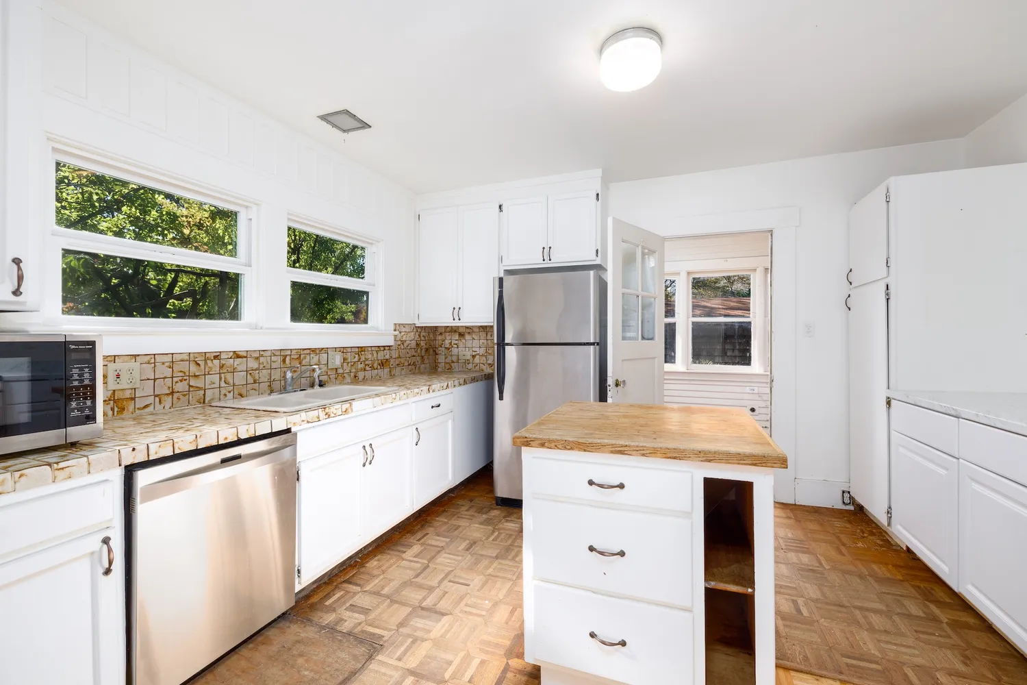 a kitchen with a stove a sink and a refrigerator