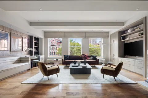 a living room with fireplace furniture and a flat screen tv
