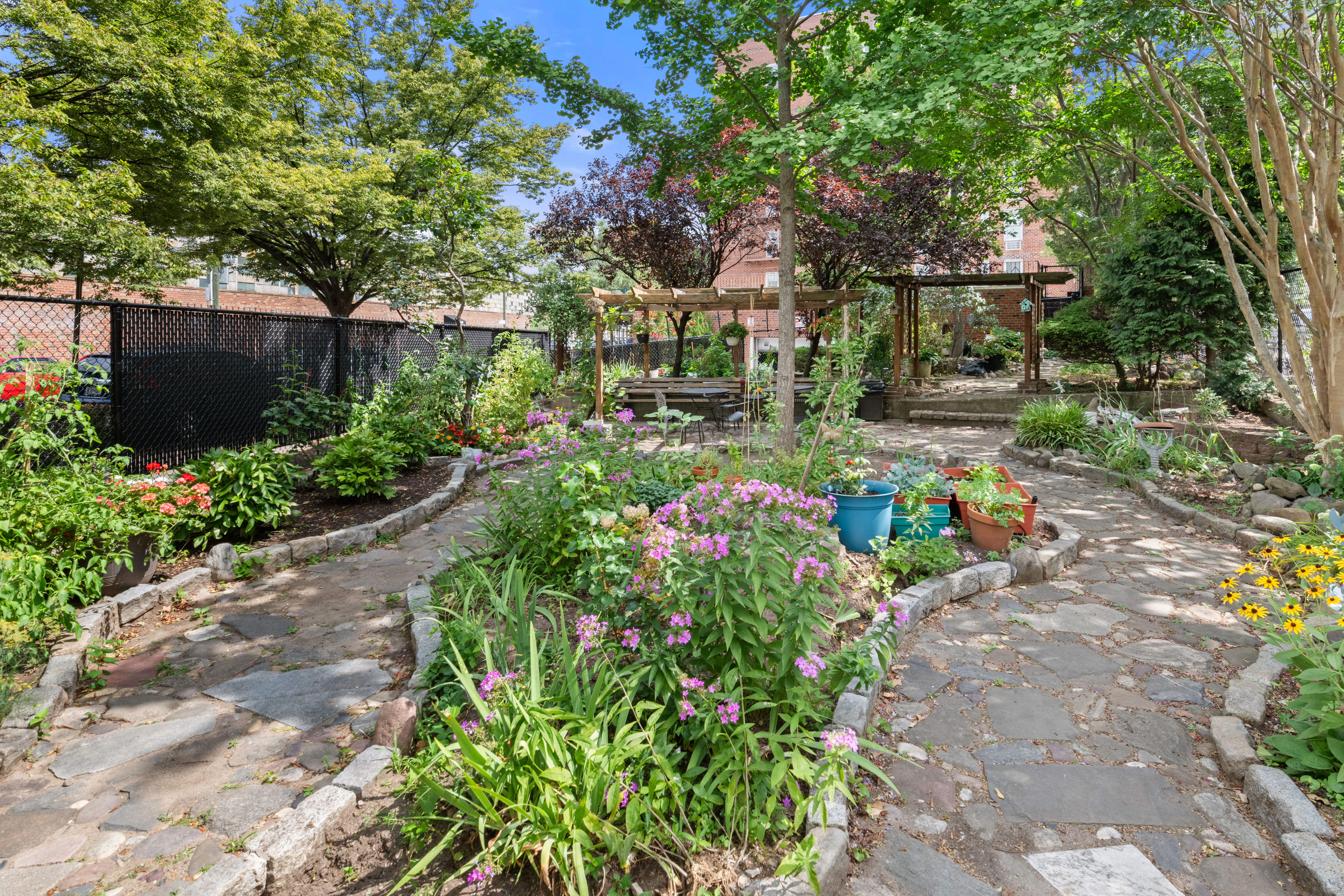 46-01 39th Avenue, Unit 509 Queens, NY 11104 - Photo 9 of 11 a view of a garden with flowers