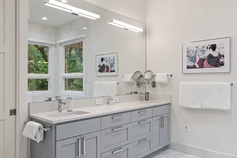 a white toilet sitting next to a bathroom sink