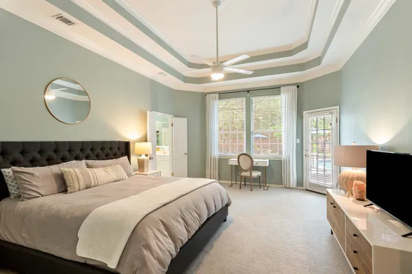 a bedroom with bed tv and window