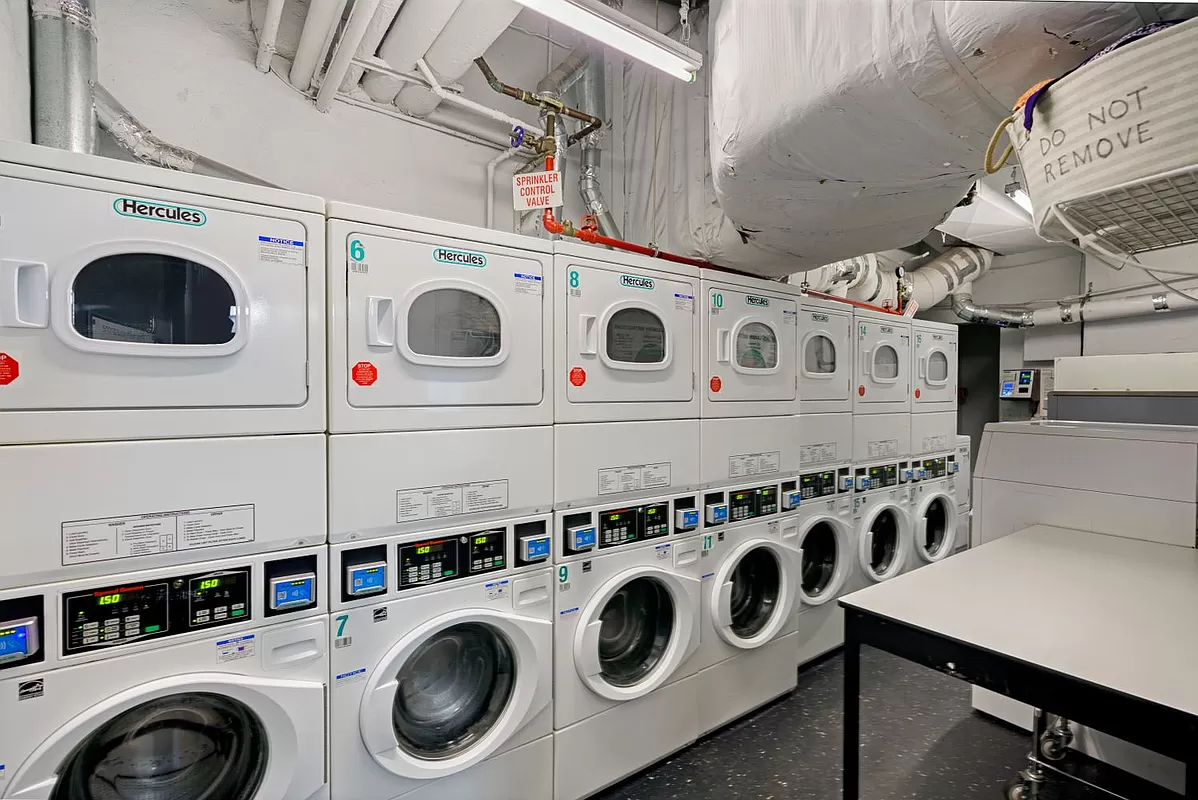 153 East 57th Street, Unit 17F Manhattan, NY 10022 - Photo 6 of 8 a utility room with dryer and washer