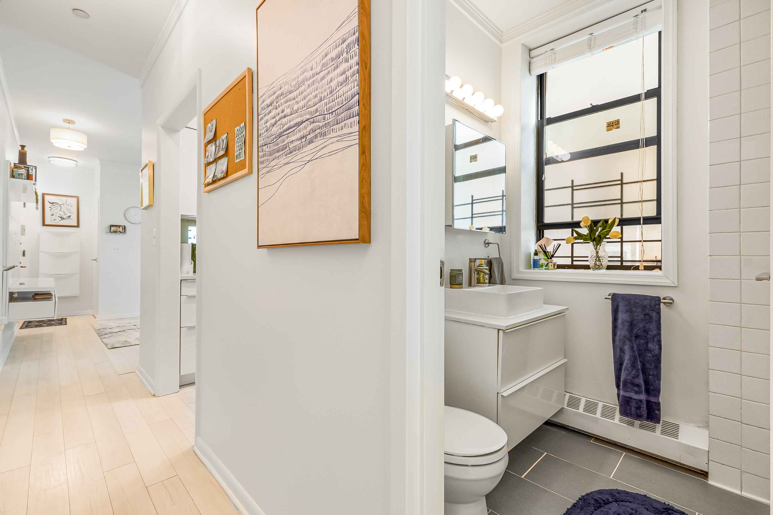 108 West 114th Street, Unit 4B Manhattan, NY 10026 - Photo 9 of 11 a bathroom with a sink toilet vanity and tub