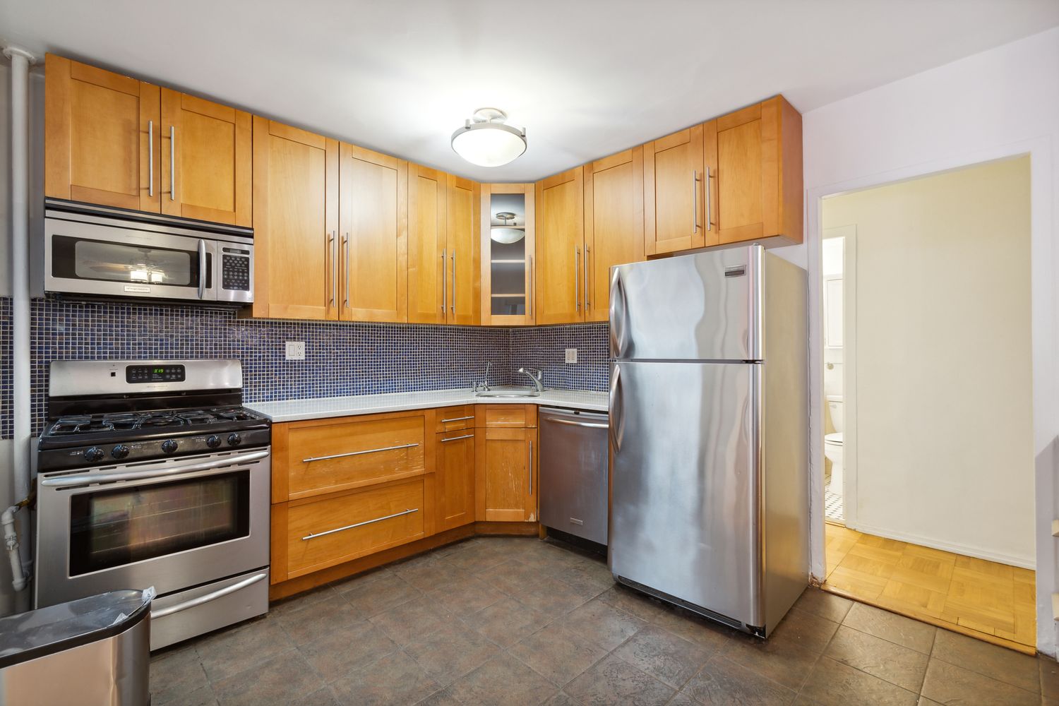 355 Clinton Avenue, Unit 1F Brooklyn, NY 11238 - Photo 5 of 14 a kitchen with granite countertop a refrigerator stove and cabinets