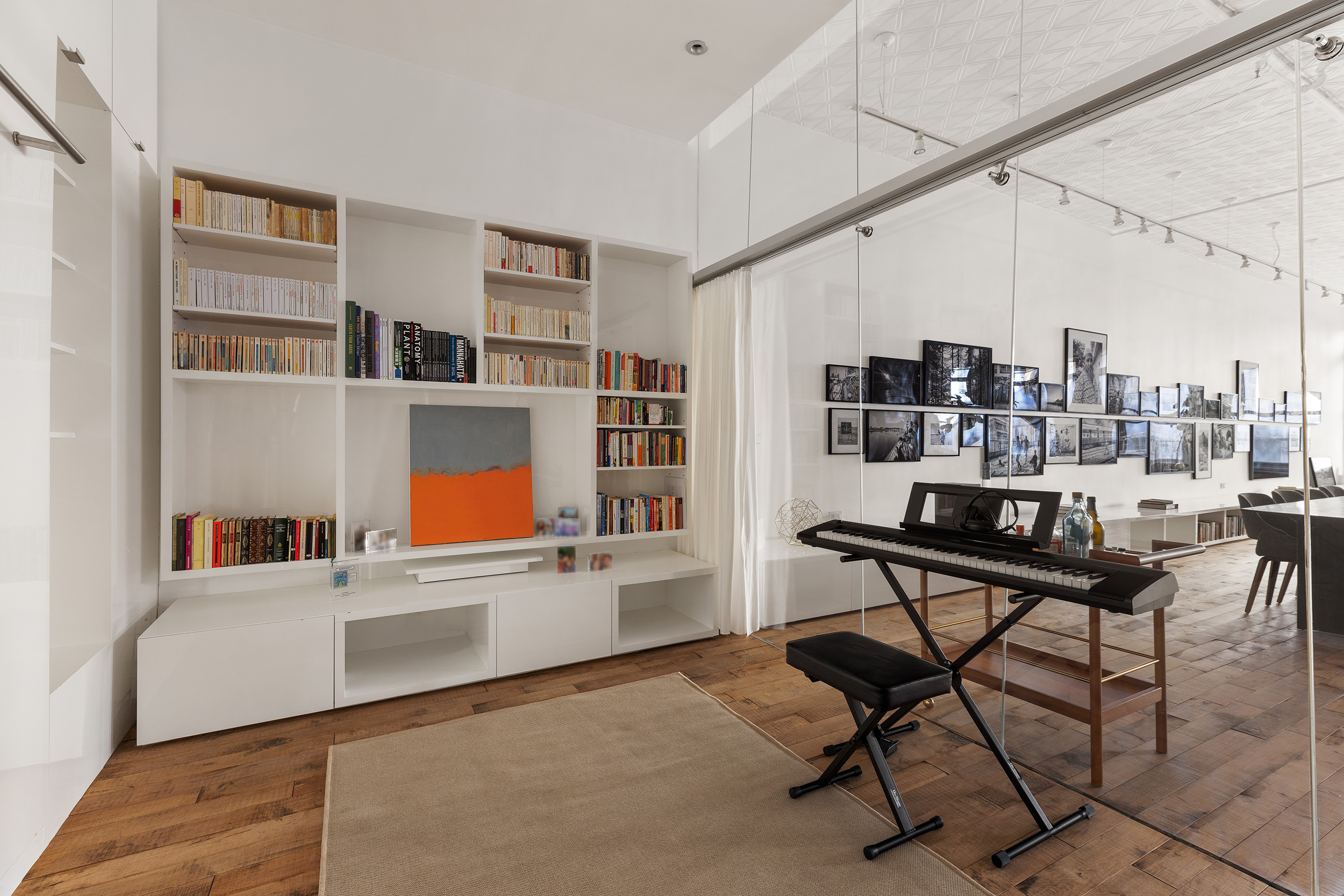 22 East 18th Street, Unit 4E Manhattan, NY 10003 - Photo 8 of 13 a living room with furniture and a book shelf
