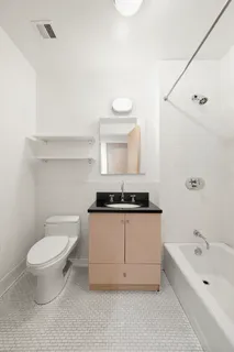 a bathroom with a sink a toilet and bathtub