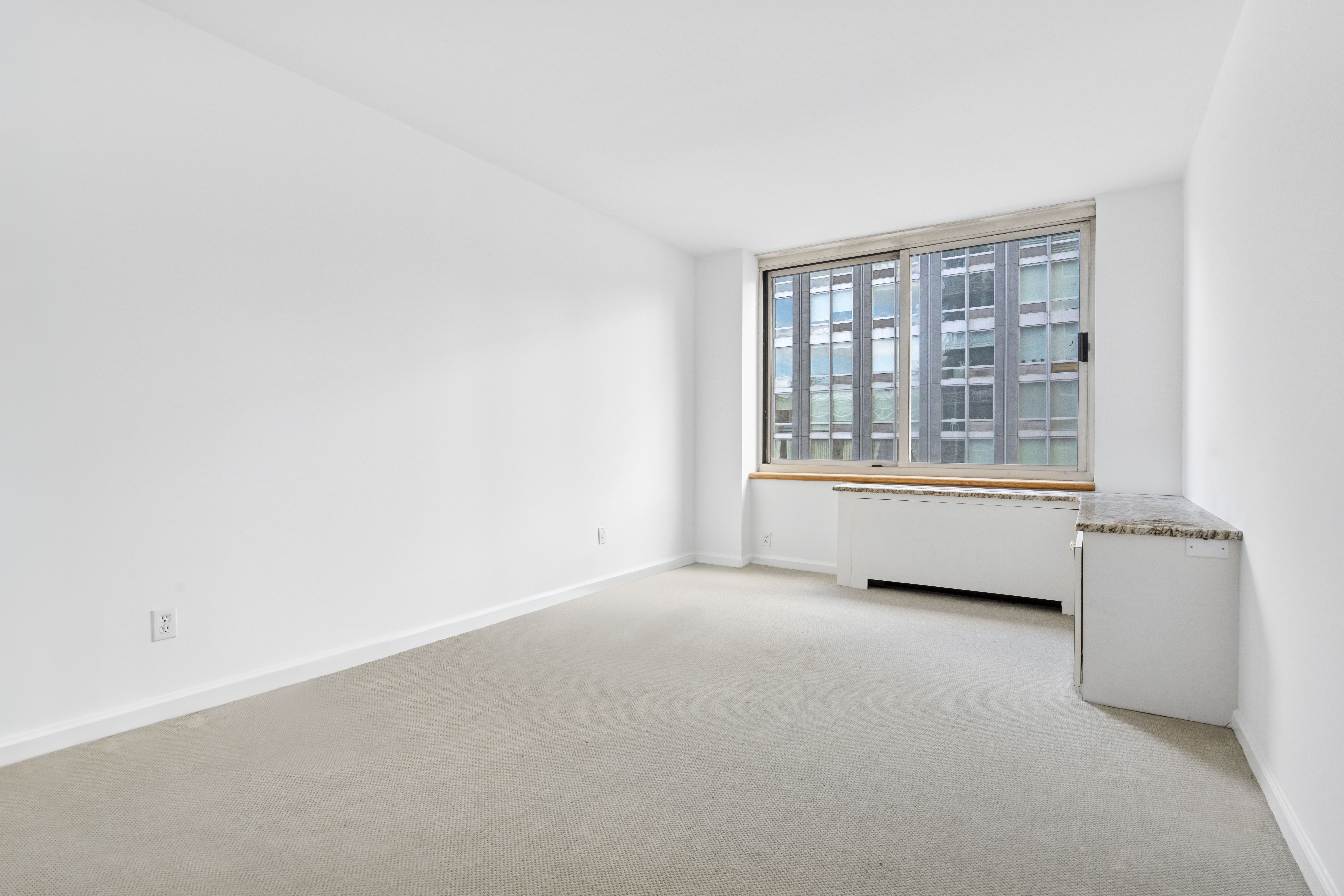 201 West 72nd Street, Unit 8A Manhattan, NY 10023 - Photo 11 of 15 a view of an empty room with a window