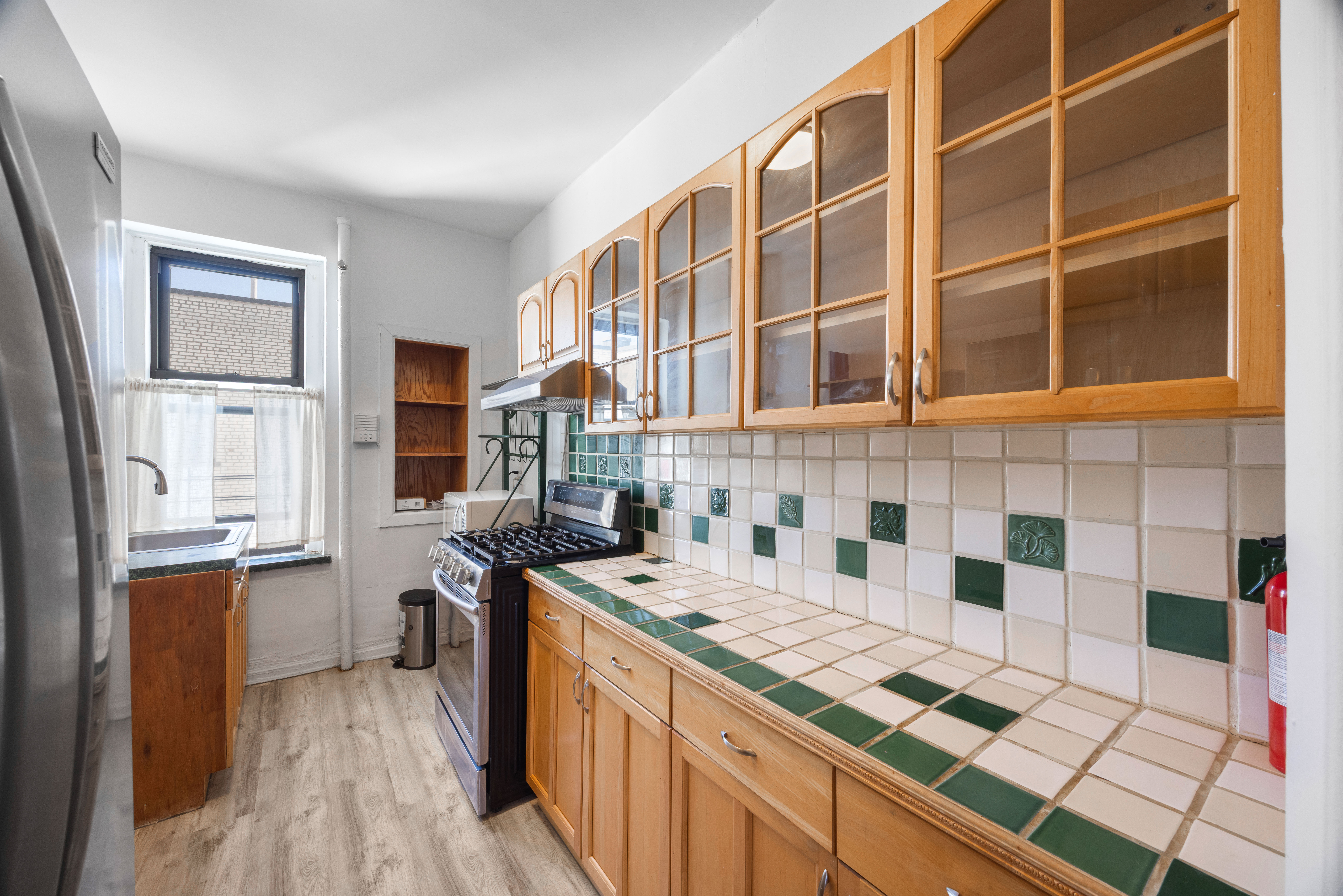 179 Ocean Parkway, Unit 4H Brooklyn, NY 11218 - Photo 4 of 11 a kitchen with stainless steel appliances granite countertop a stove and a sink