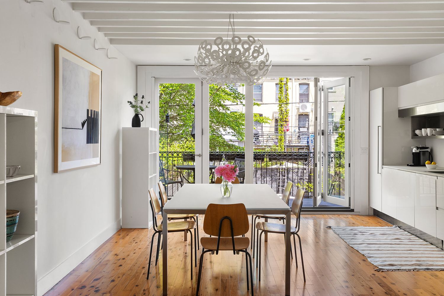a view of a dining room with furniture large windows and wooden floor