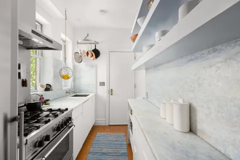 a kitchen with a sink and a stove top oven
