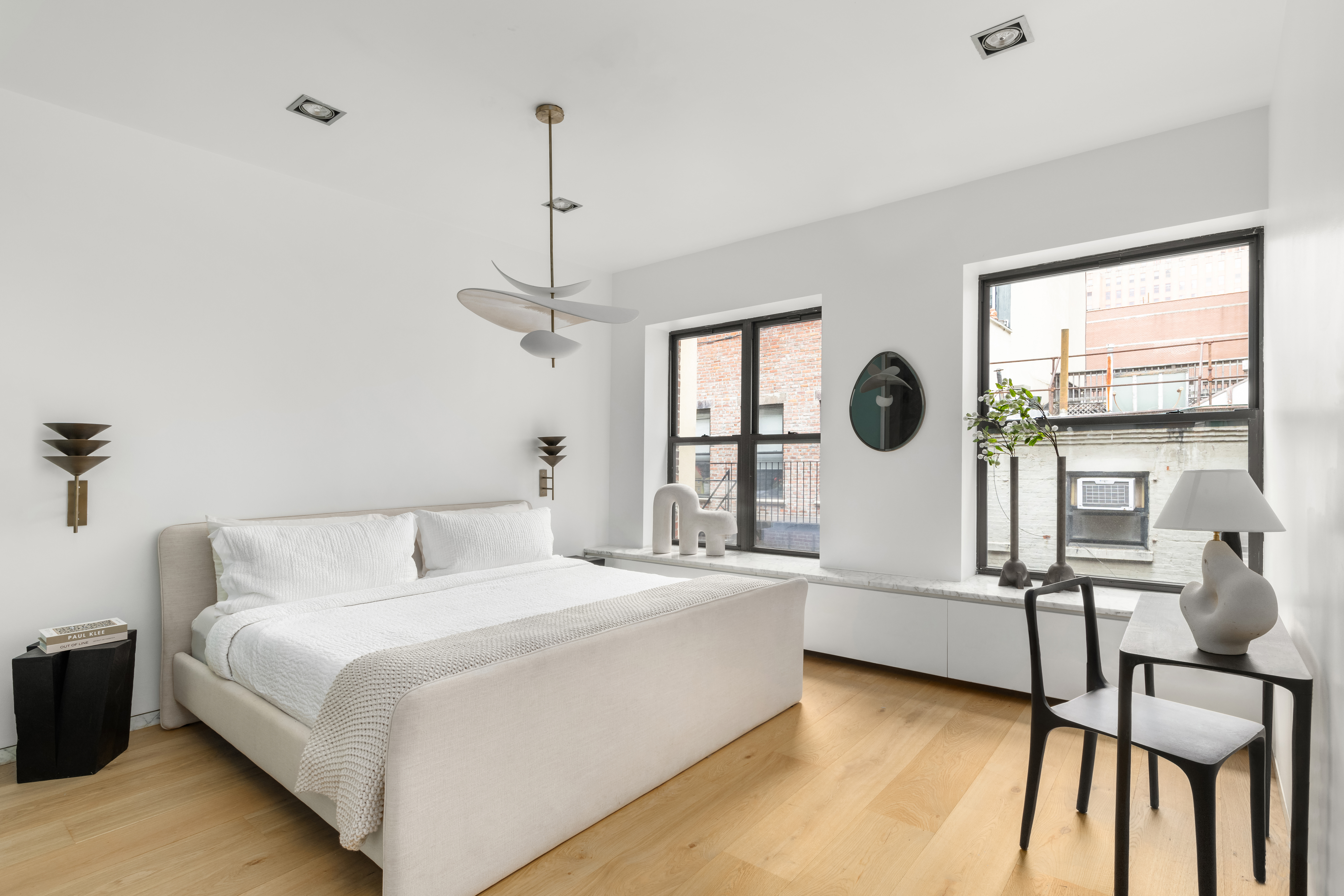 74 Warren Street, Unit 5W Manhattan, NY 10007 - Photo 9 of 15 a bedroom with a bed a window and a couch