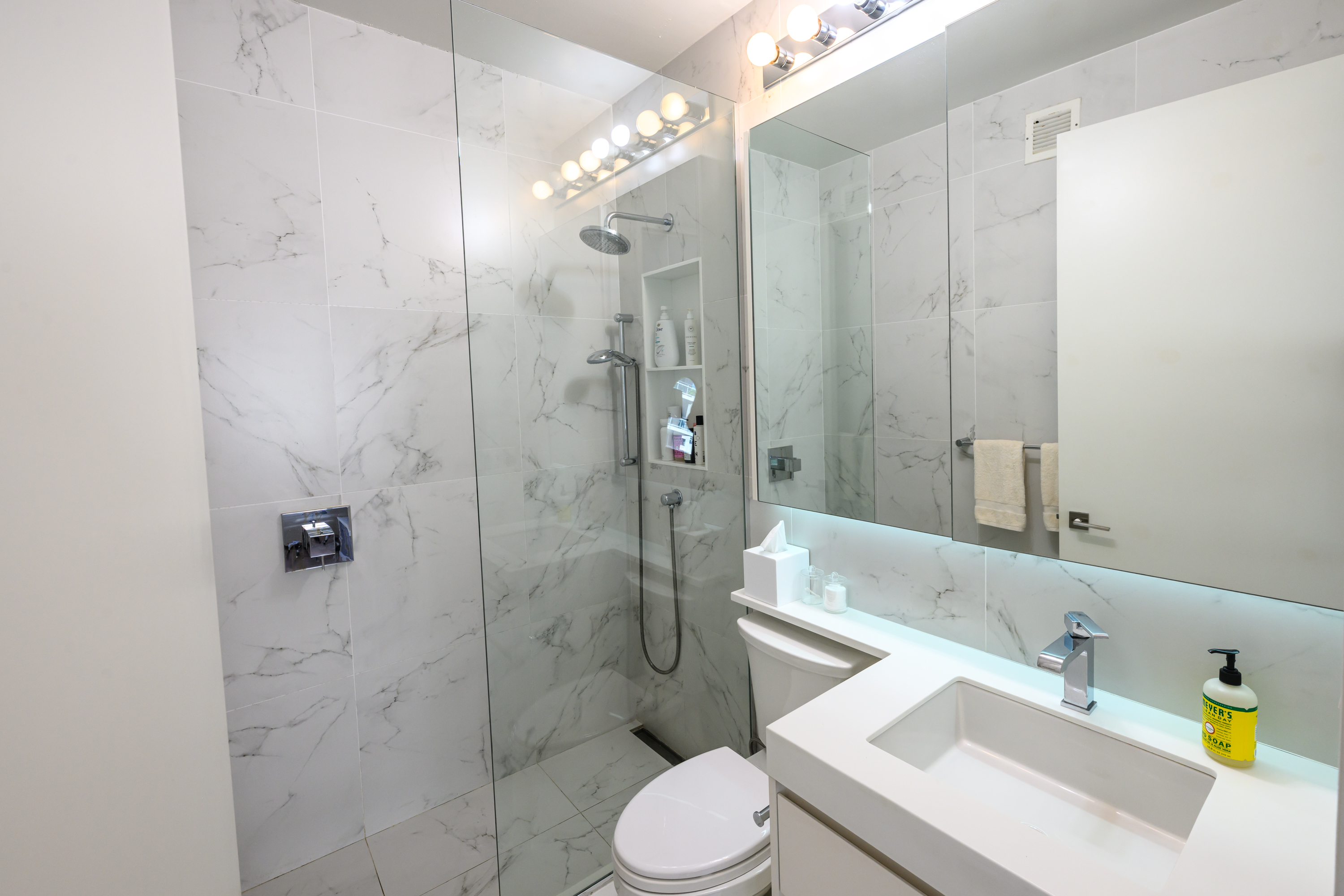 200-210 East 65th Street, Unit 11D Manhattan, NY 10065 - Photo 11 of 15 a bathroom with a sink toilet and shower