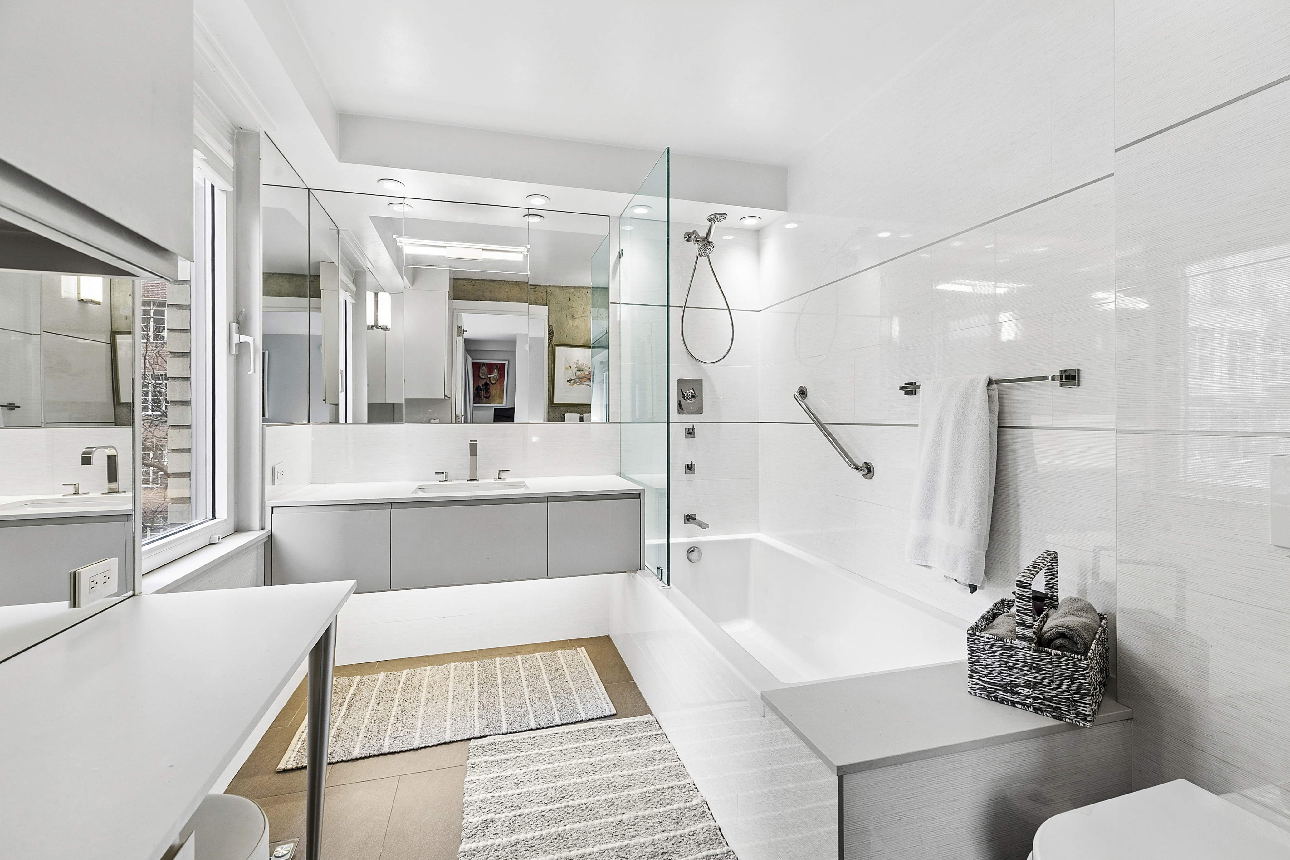 1065 Park Avenue, Unit 4BC Manhattan, NY 10128 - Photo 7 of 16 a bathroom with a tub sink toilet and mirror