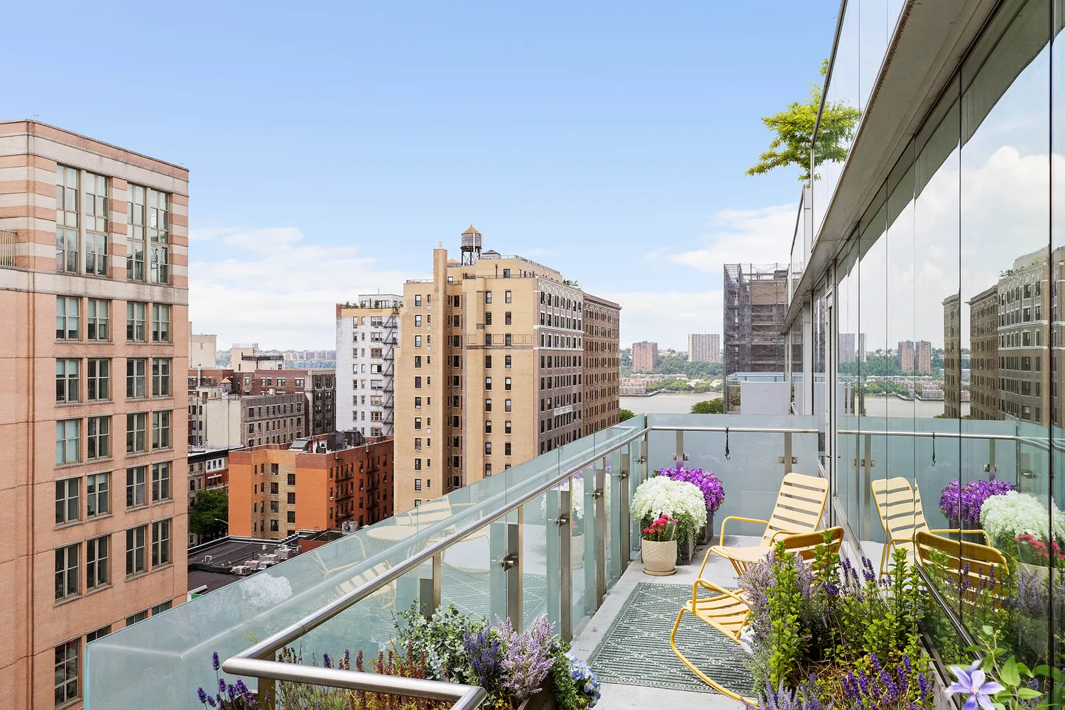 a city view from a balcony with outdoor seating